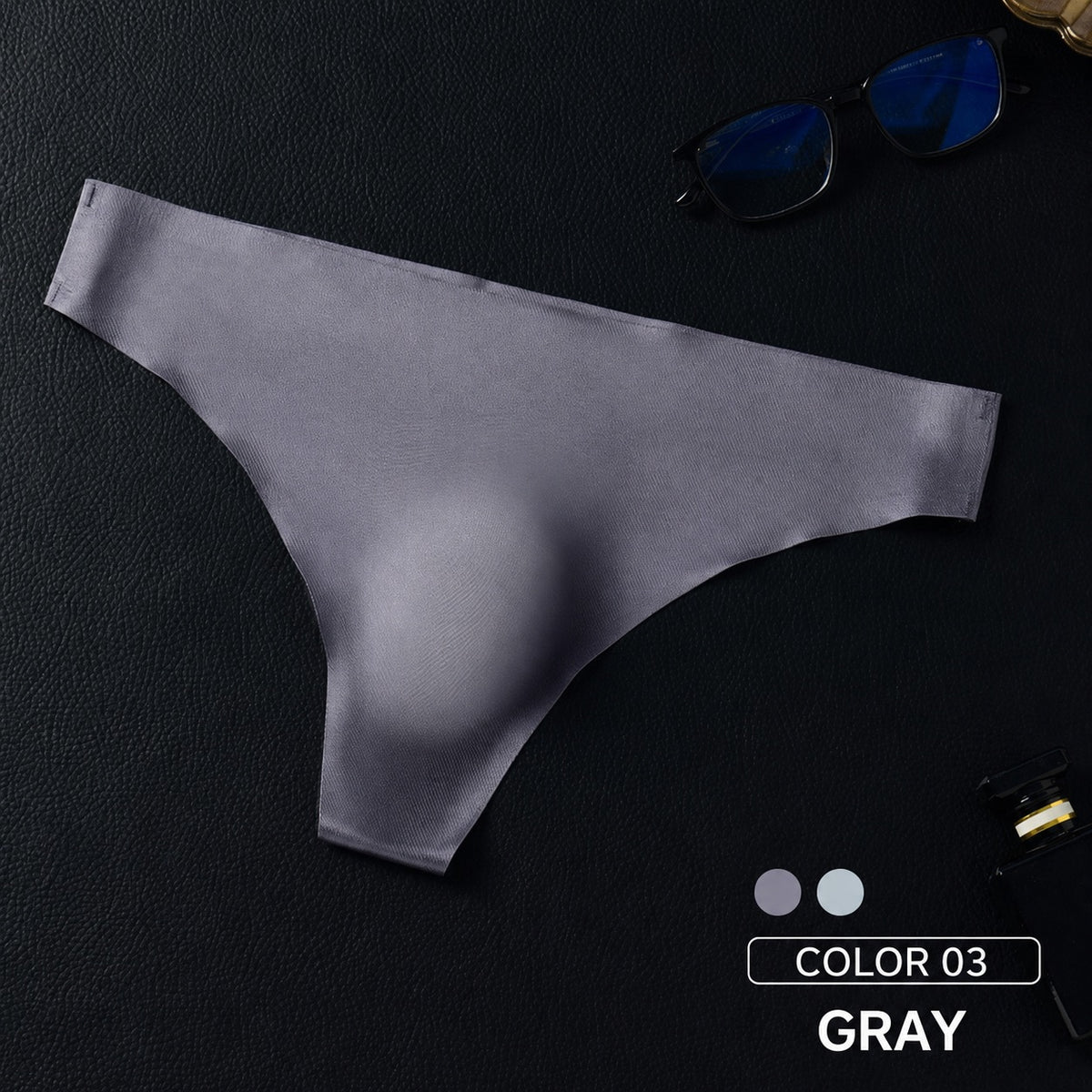 Gray MemoSkin lightweight low-rise men's thong underwear showing a seamless profile and flexible waistband designed for an invisible fit under pants.