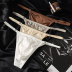 A close-up view focusing on the front pouch of the MemoSkin Smooth Low-Rise Men's Thong in white. The detailed shot highlights the fine texture of the smooth nylon-spandex knit and the clean stitching. This comfortable, minimalist men's thong is designed with a low-rise fit for a sleek look, making it suitable for discreet, everyday wear as part of an international men's underwear wardrobe.