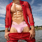 Model wearing pink men’s lace jockstrap underwear with red clothing